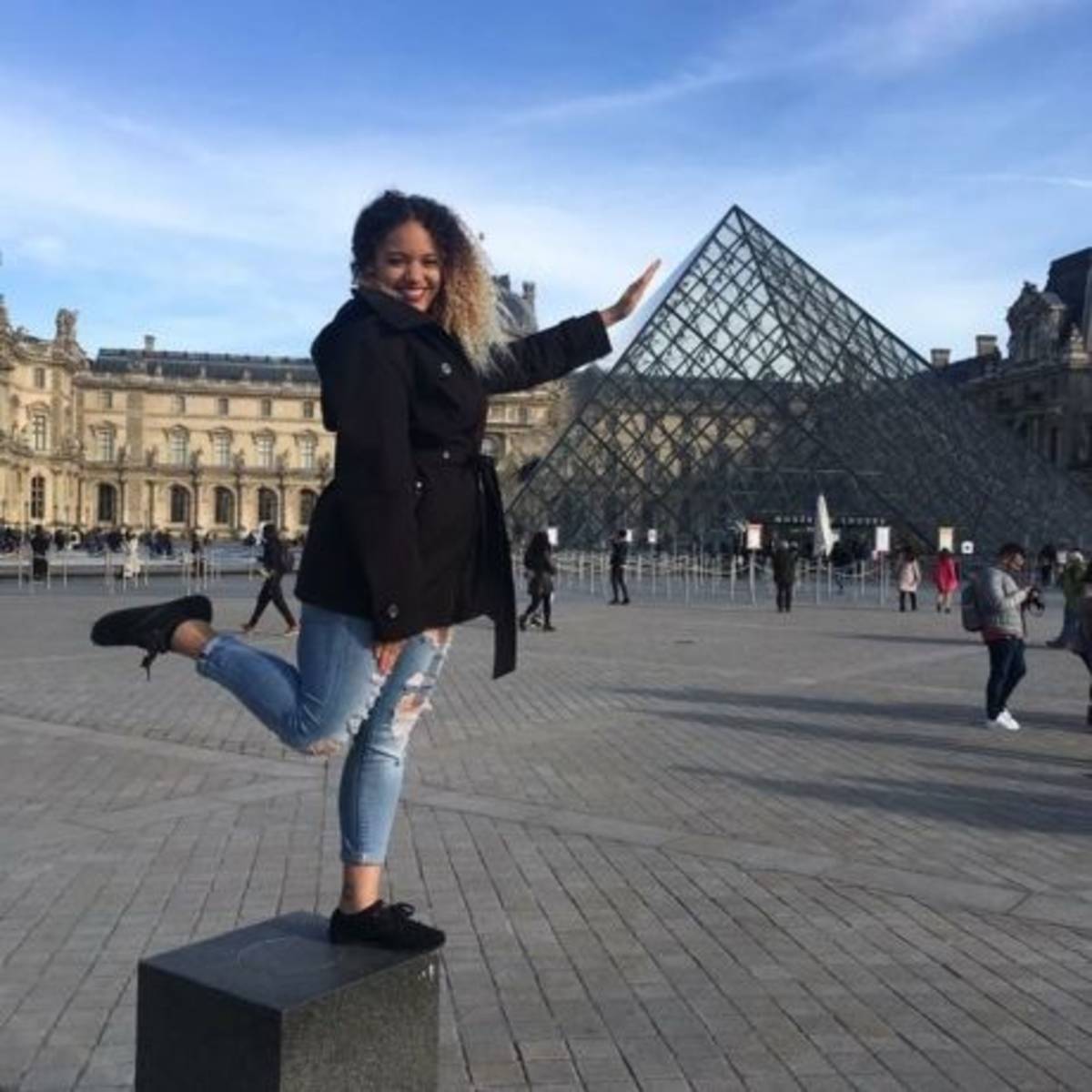 Student posing with the Louvre pyramid