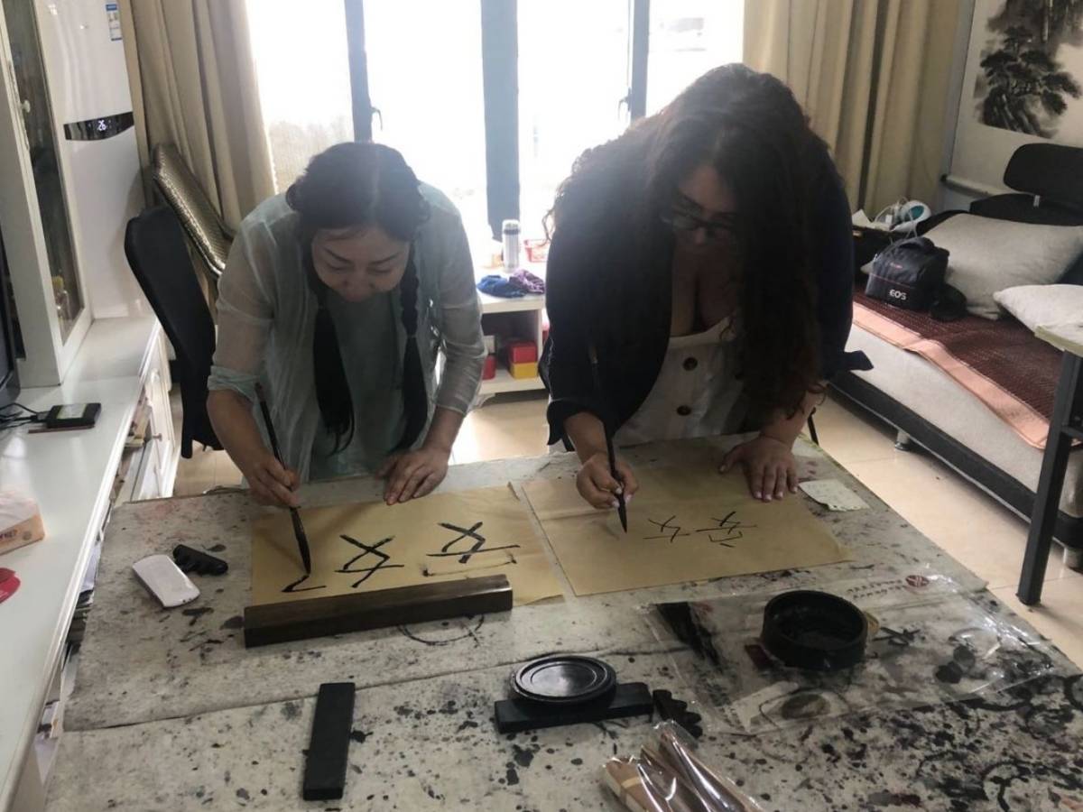 Student practicing Chinese calligraphy in Chengdu