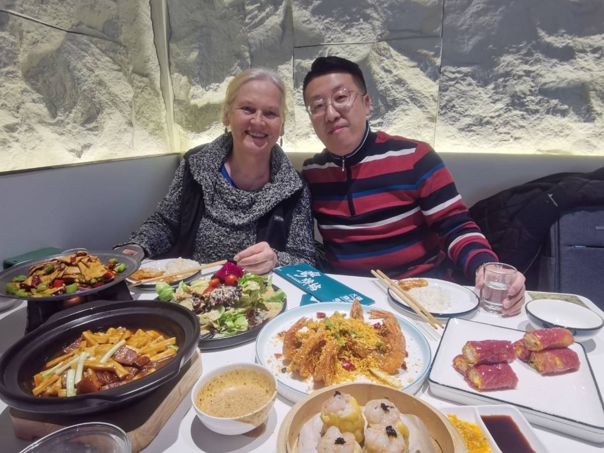 Student sharing a meal with her teacher in Dalian
