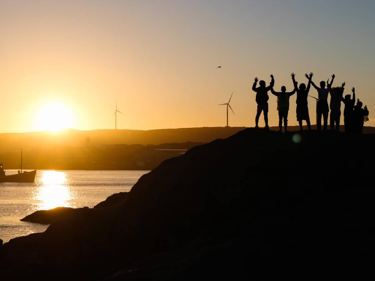 Student silhouettes at sunrise over Lüderitz