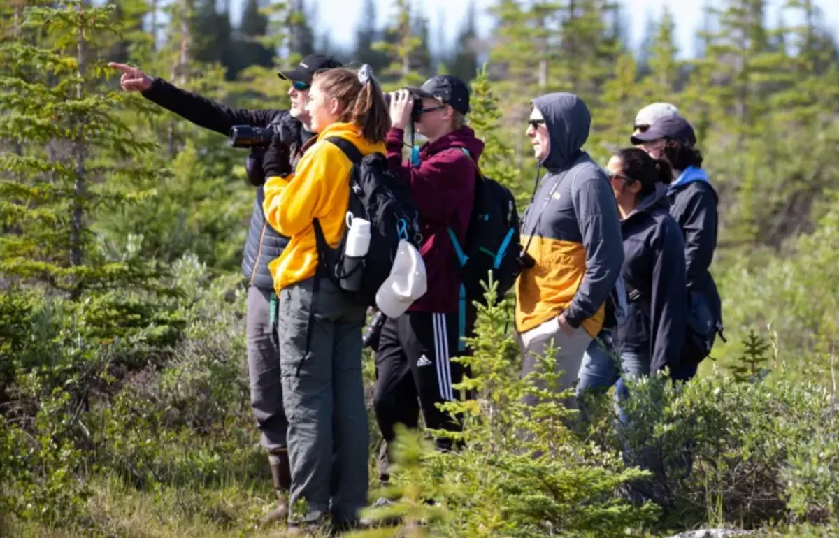 Student take photos in the woods