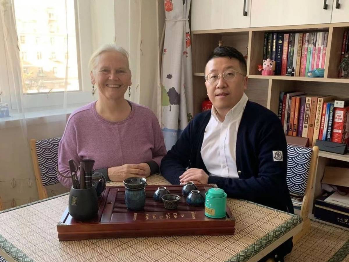 Student taking part in a tea ceremony with her teacher in Dalian