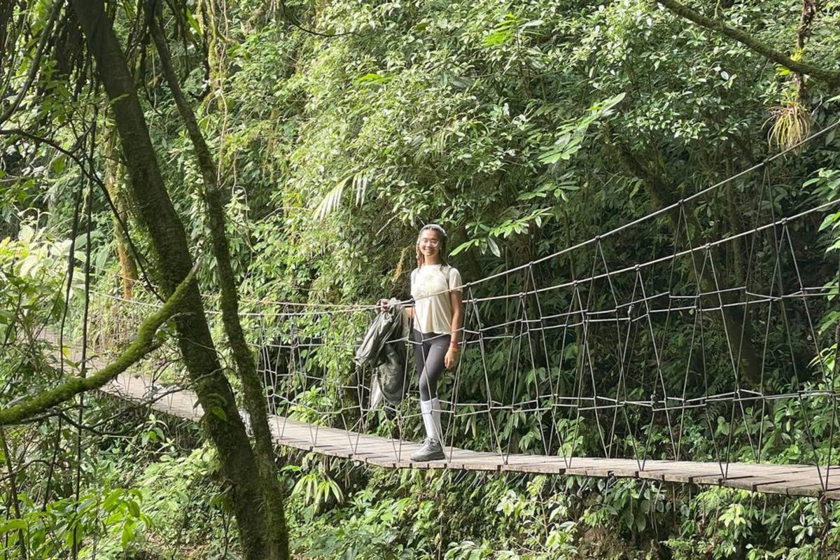 Student walking across bridge in Monteverde forest