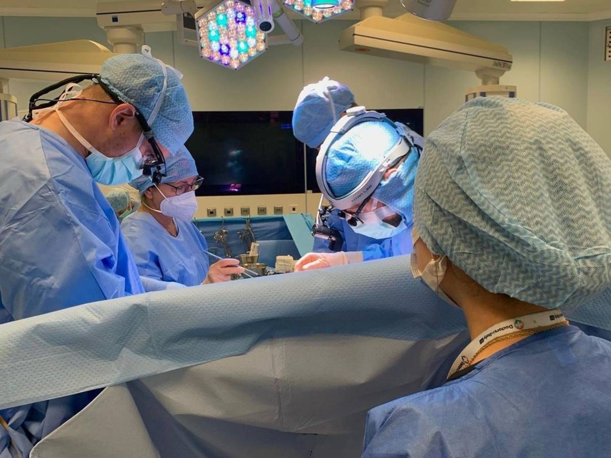 Student watching surgery being performed in the OR.