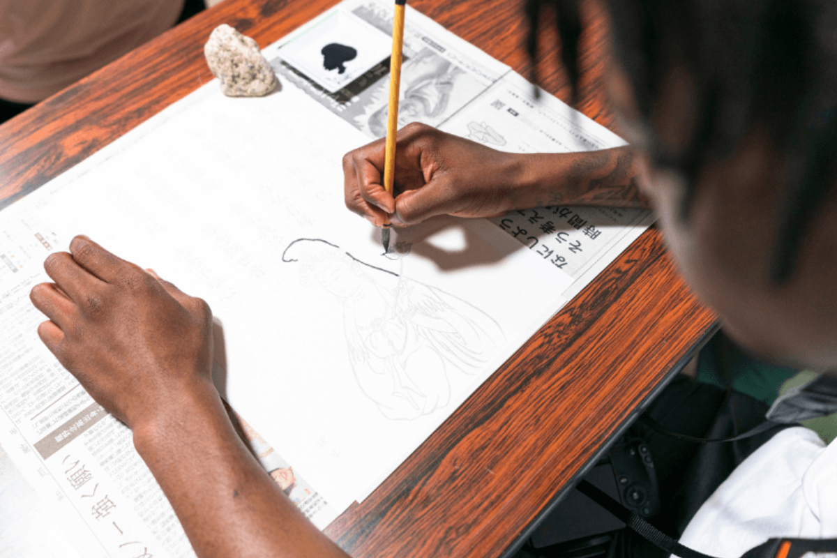Student writing and drawing