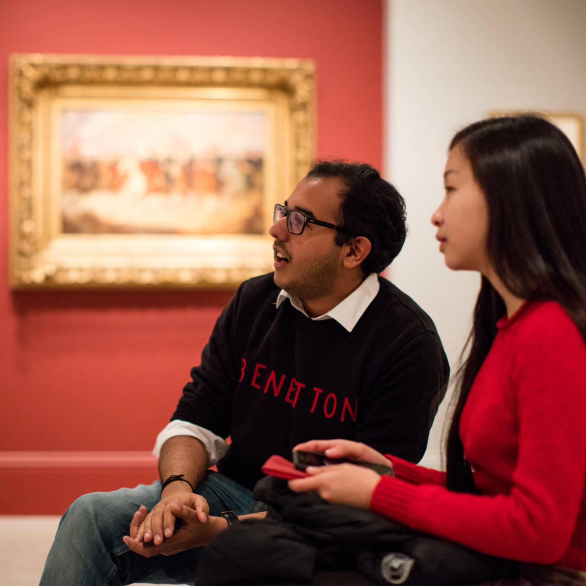 Students admire a painting.