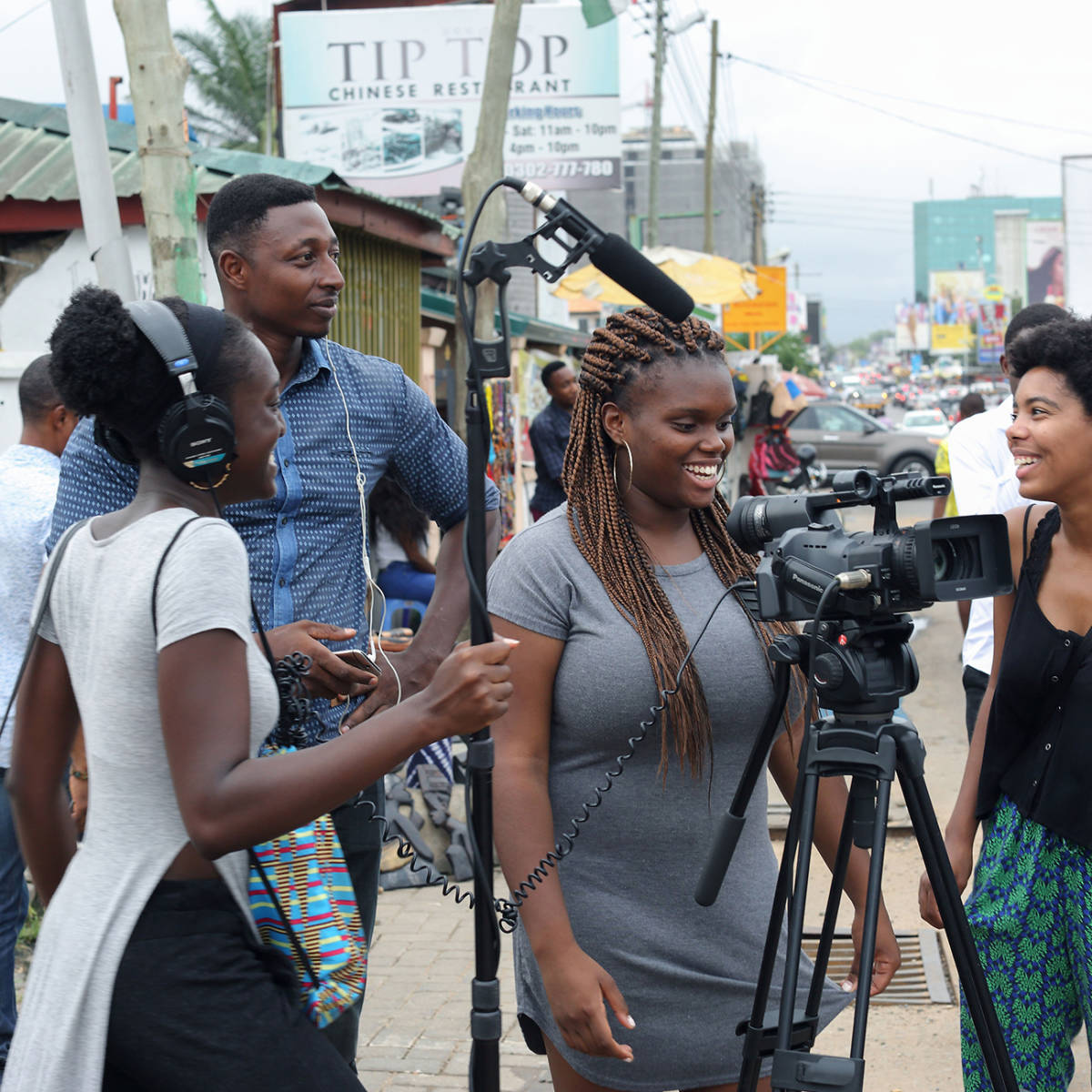 Students and an adviser film a project outside