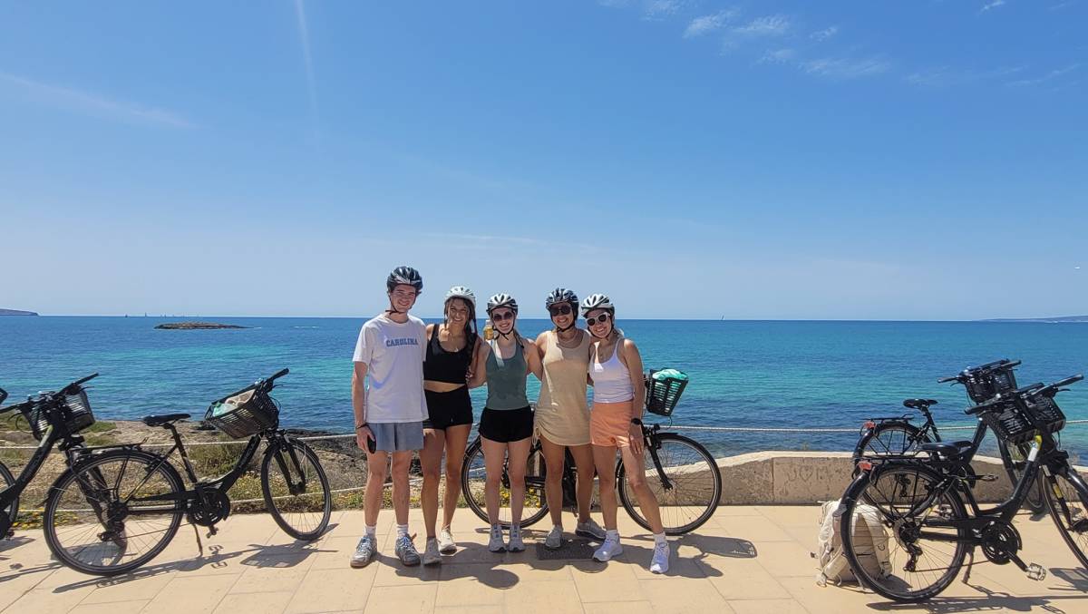 Students biking near the ocean in Palma de Mallorca
