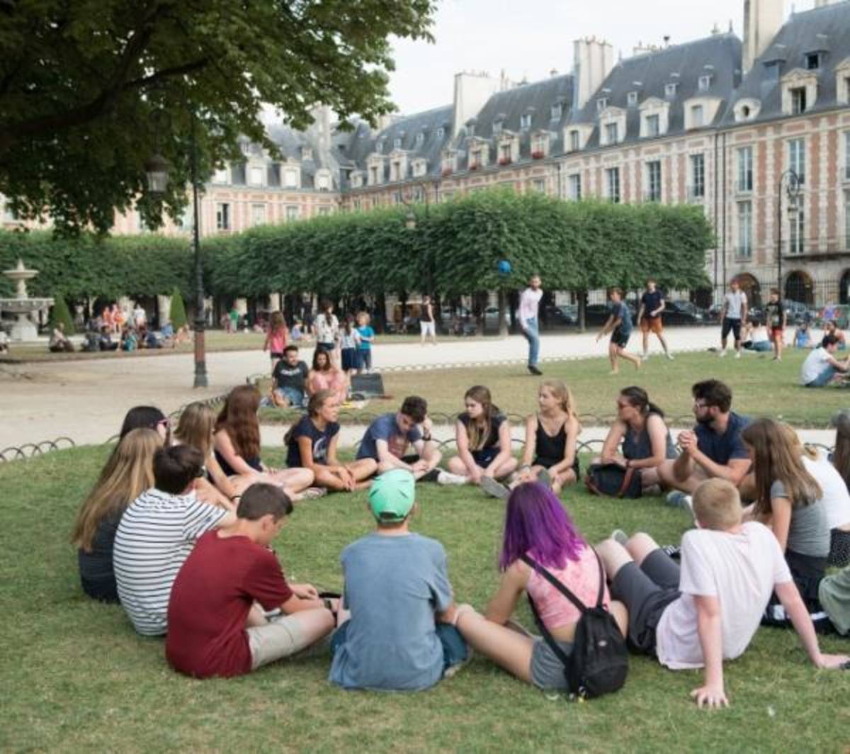 students sitting in a circle for french lessons
