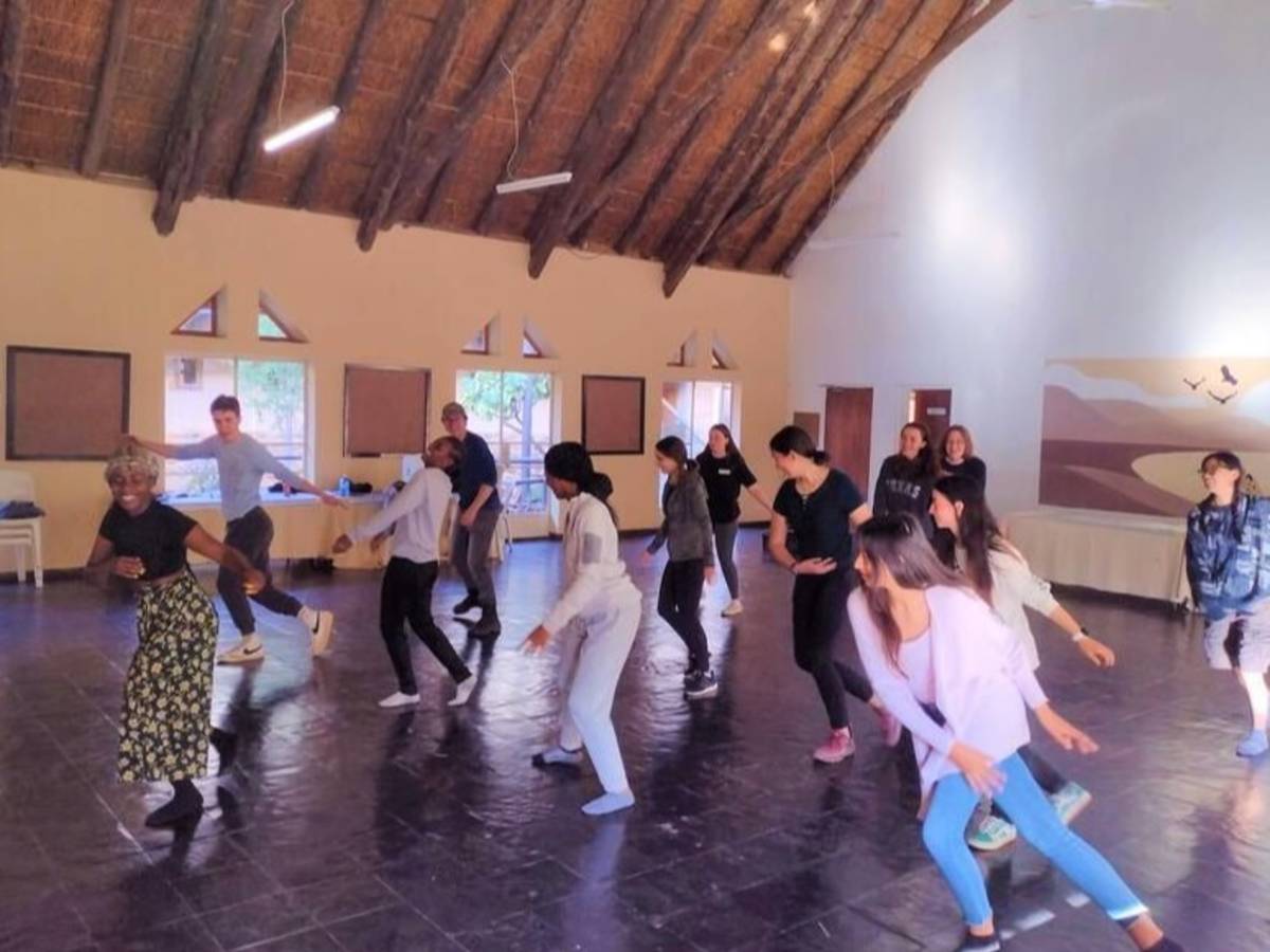Students dancing with local instructor in Gaborone