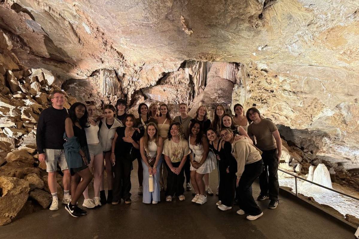 Students exploring Prague cave