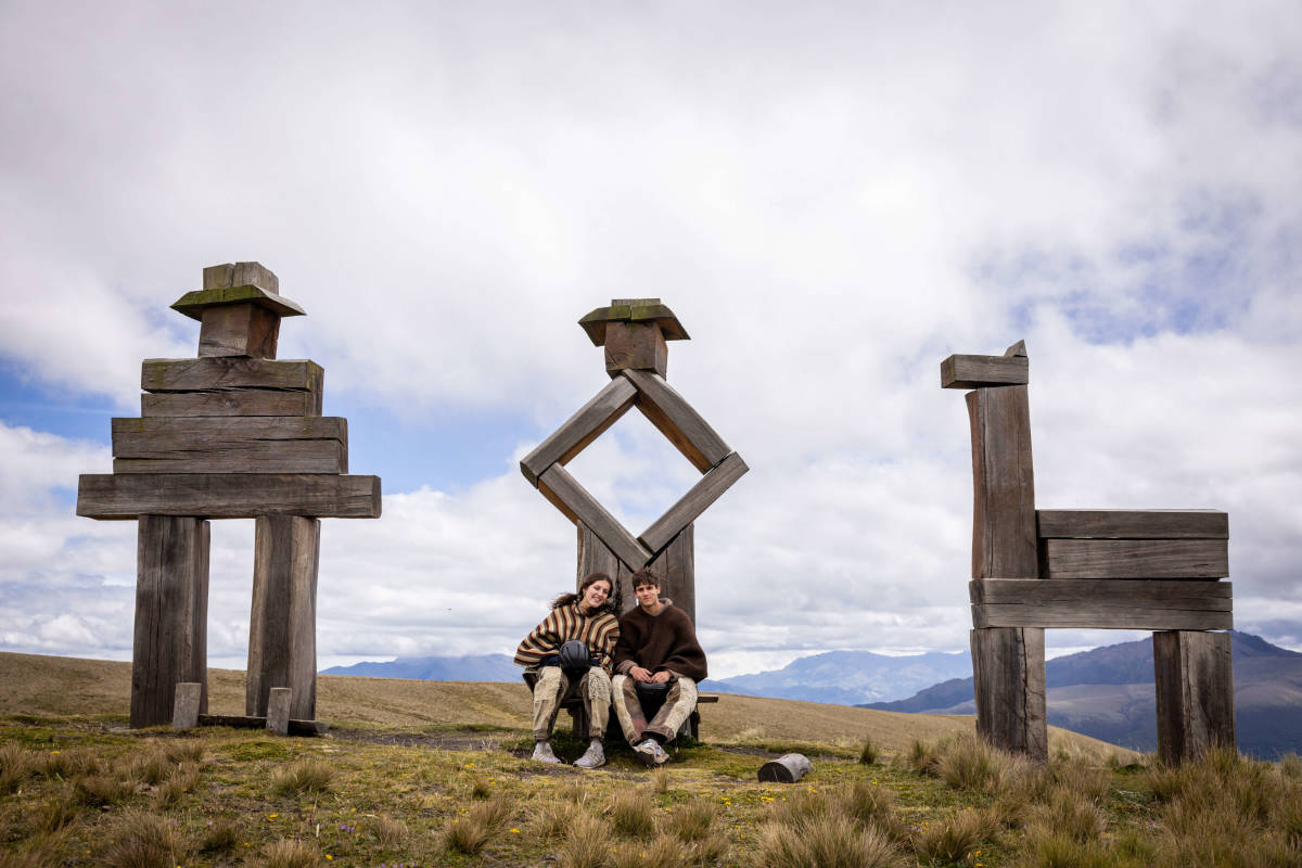 students in front of wood sculptures