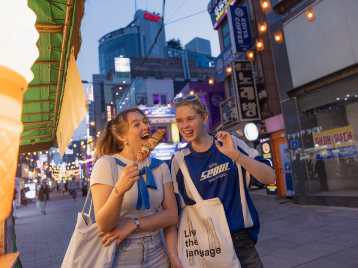 Students in Seoul experience Korean traditions by wearing hanbok and visiting historic palaces, combining cultural immersion with language learning.