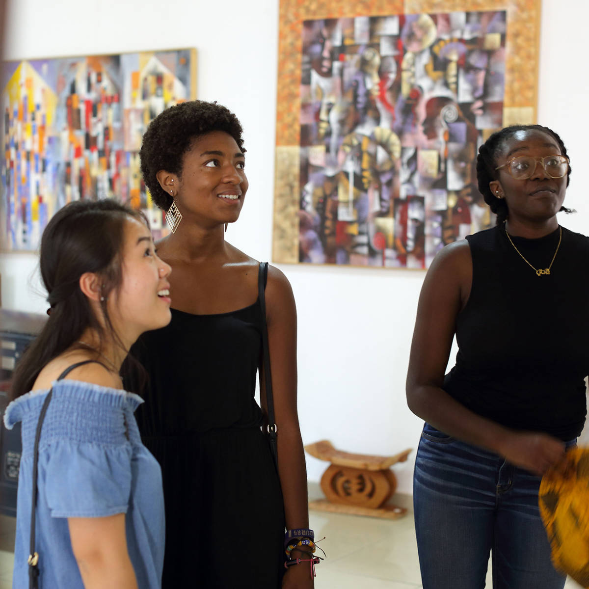 Students look at artwork in a gallery.
