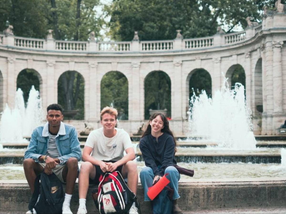 Students lounge by a fountain in between classes in Berlin, Germany.