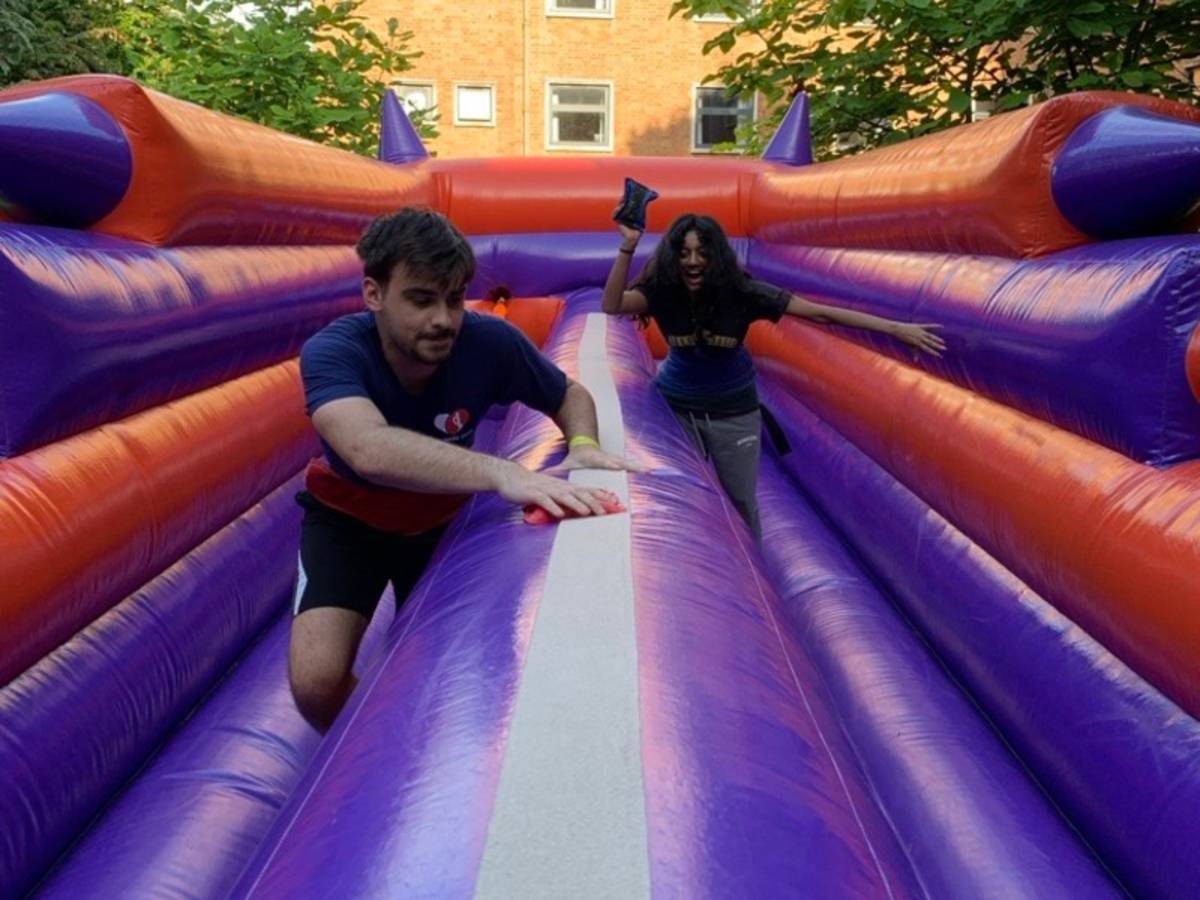 Students playing on an inflatable game