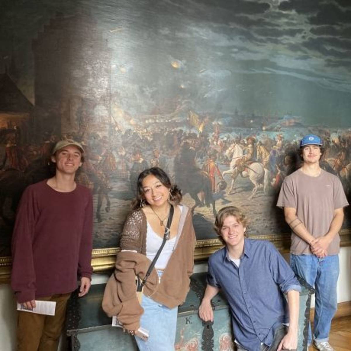 Students posing by painting in Copenhagen art museum