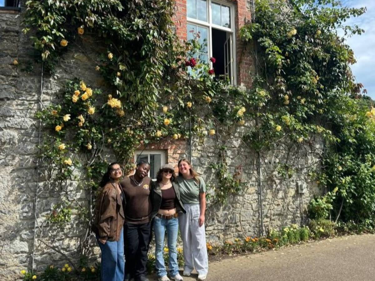 Students posing near ivy walled building in Dublin