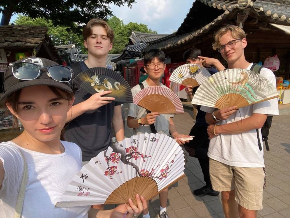 Students posing with fans in Seoul