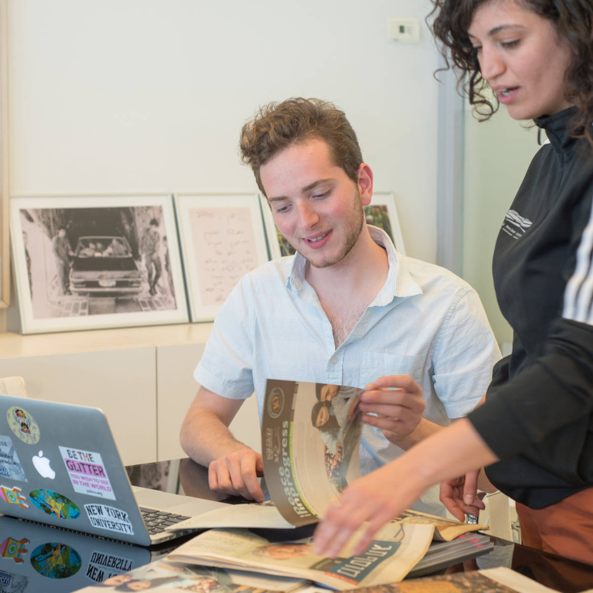 Students sit at a laptop.