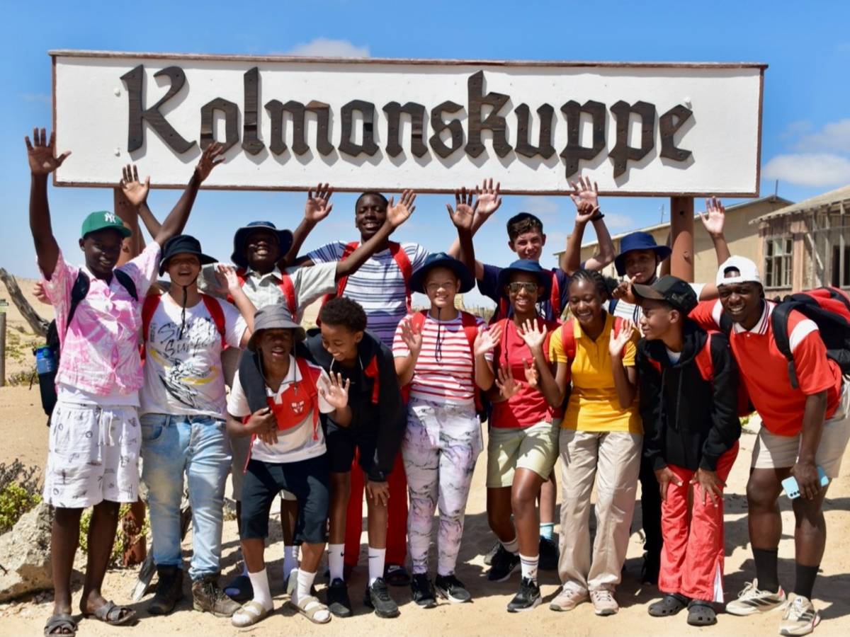 Students standing by 'Kolmanskuppe' sign