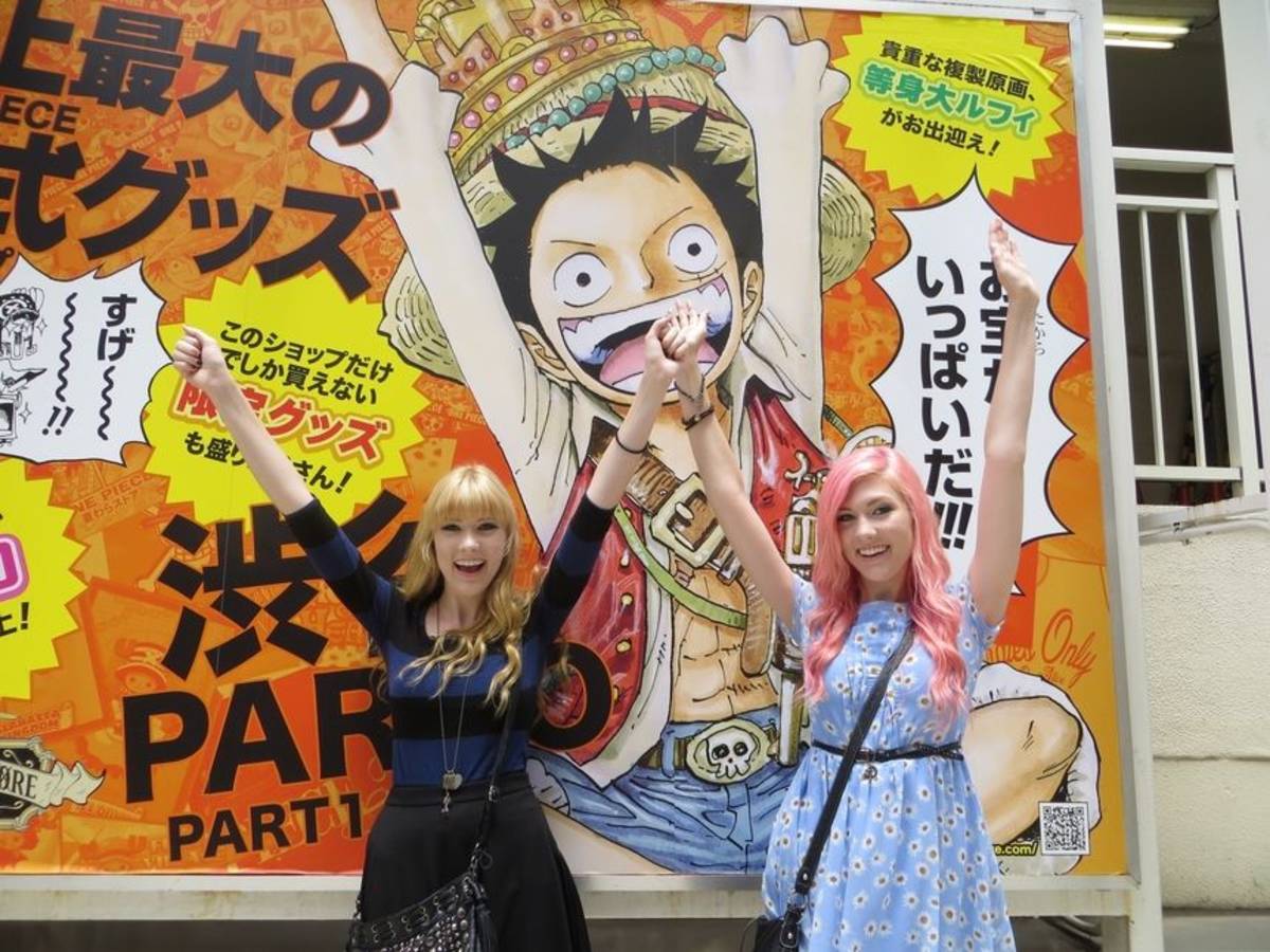 Students standing in front of one piece luffy poster