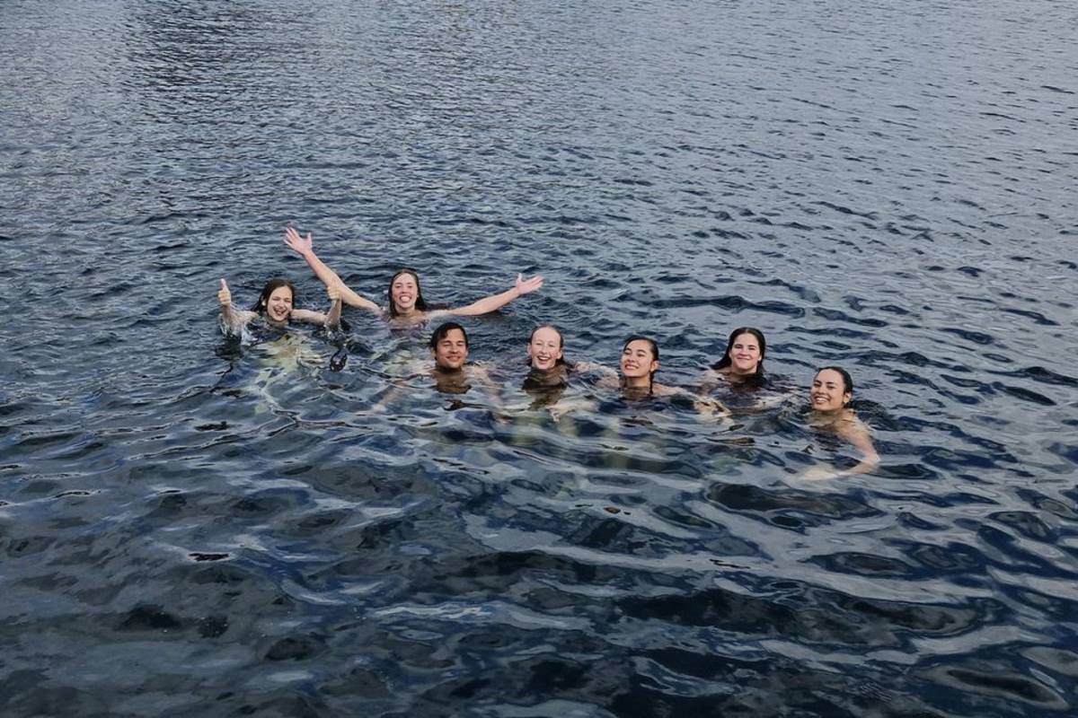 Students swimming in the water by Denmark coastline