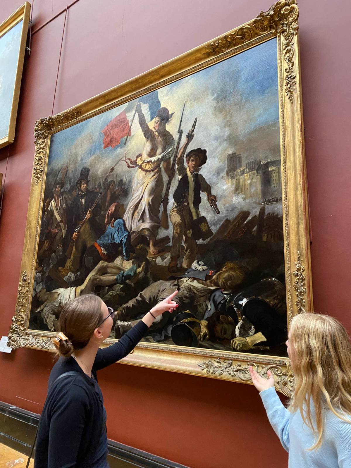 Students viewing French painting at the Louvre Museum in Paris