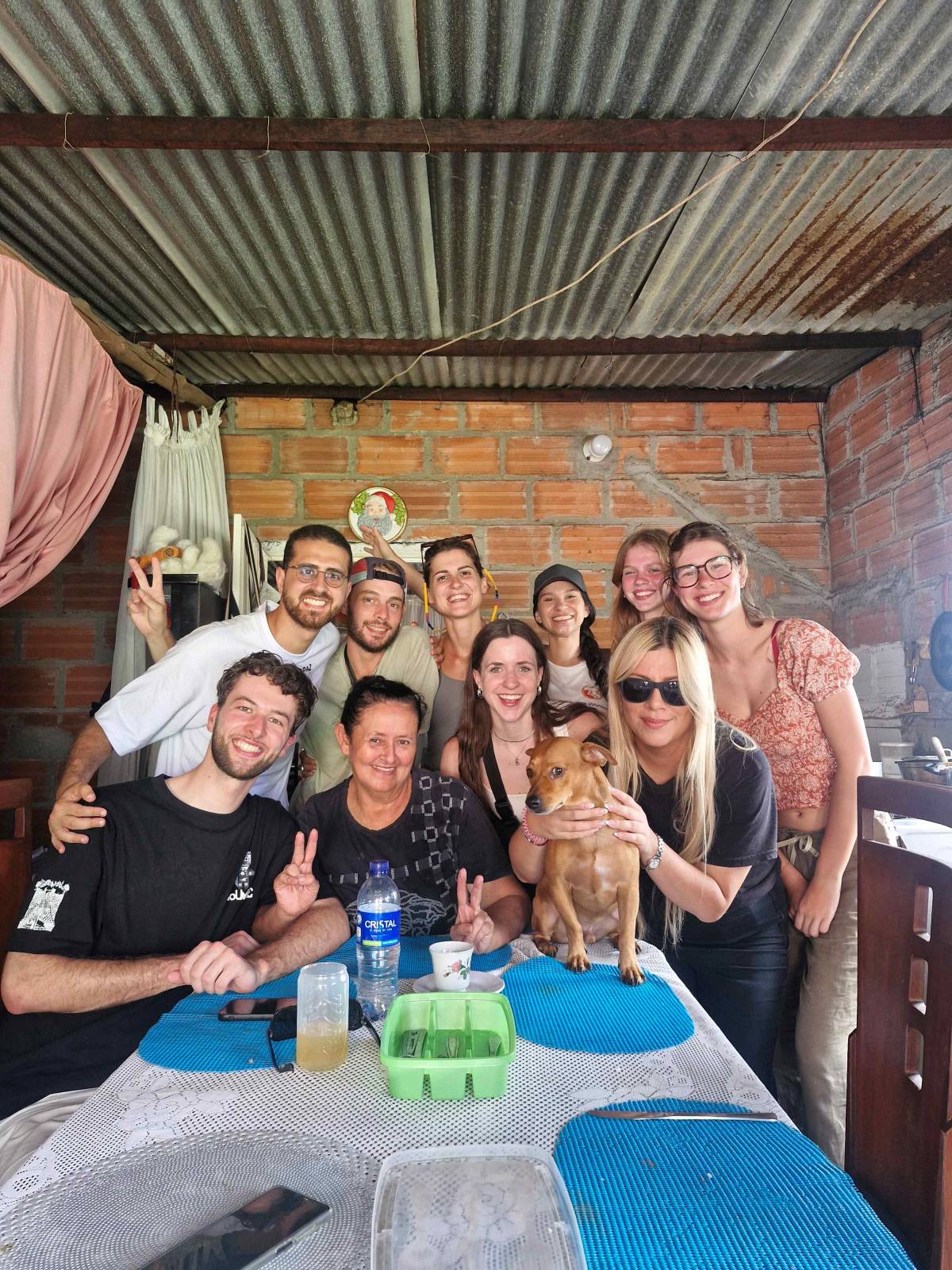 team of volunteers enjoying a traditional meal at a local family's home