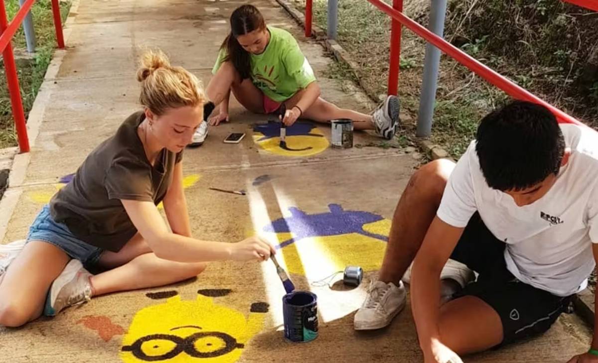 Teen Volunteers Painting a Sidewalk in Costa Rica