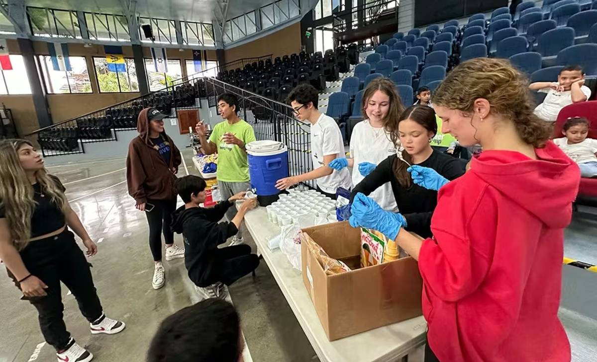 Teen Volunteers Preparing Drinks and Ice Cream to give out