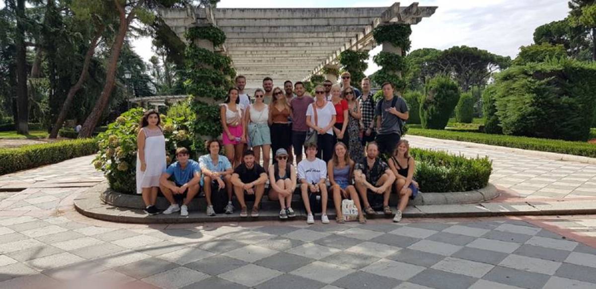 This image shows a group of people posing for a photo a park