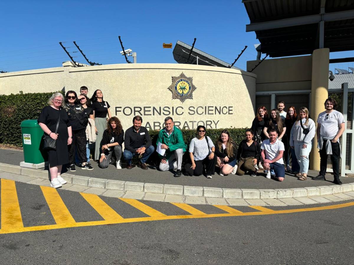 This image shows a group of people visiting a South African Police Service (SAPS) Forensic Science Laboratory