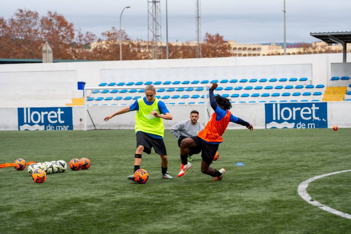 three people playing soccer
