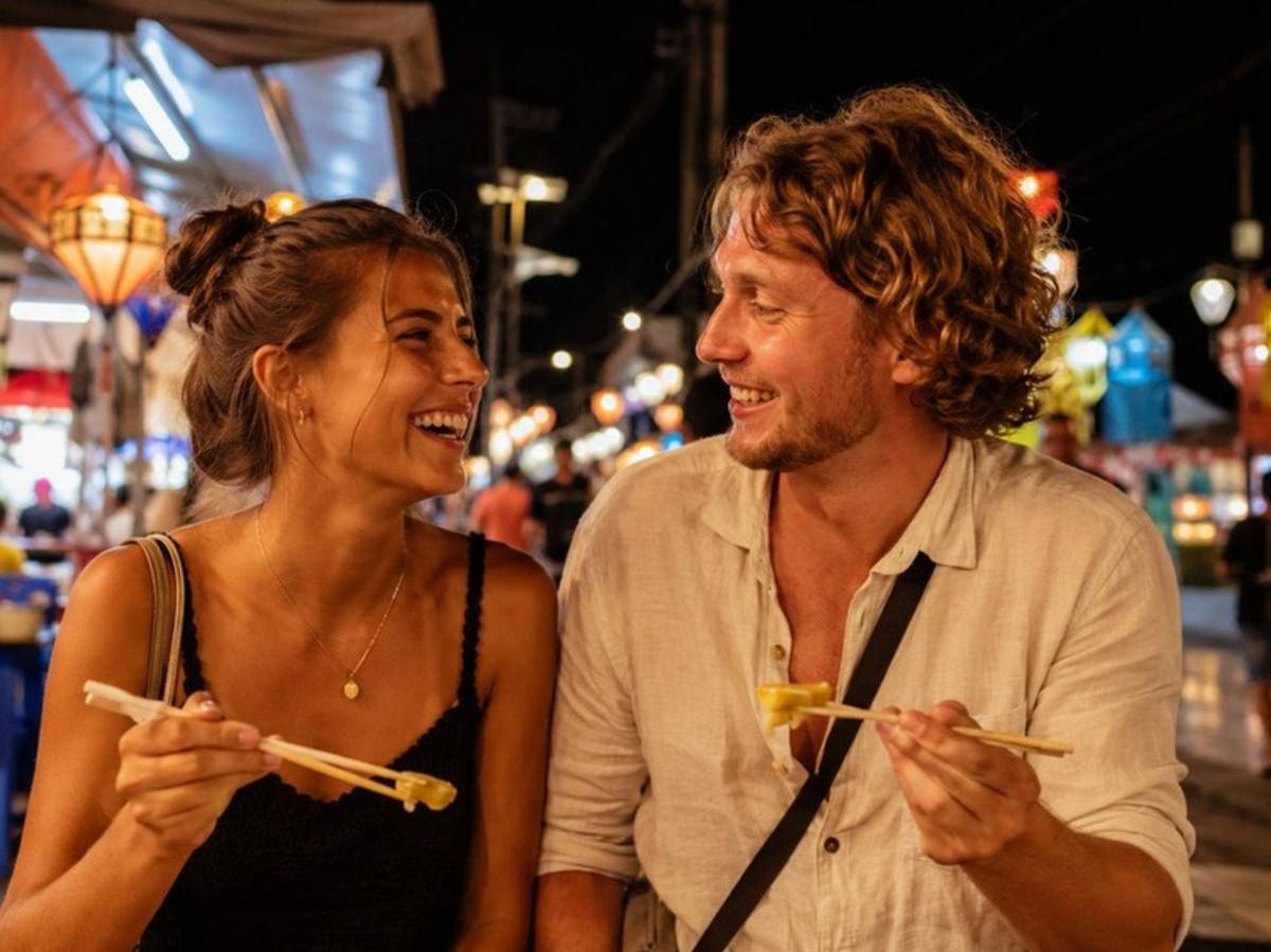 Travellers enjoying street food together at a Thai night market