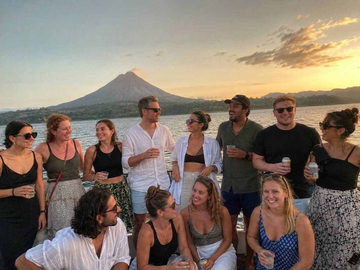 Travellers enjoying sunset drinks beside Arenal Volcano