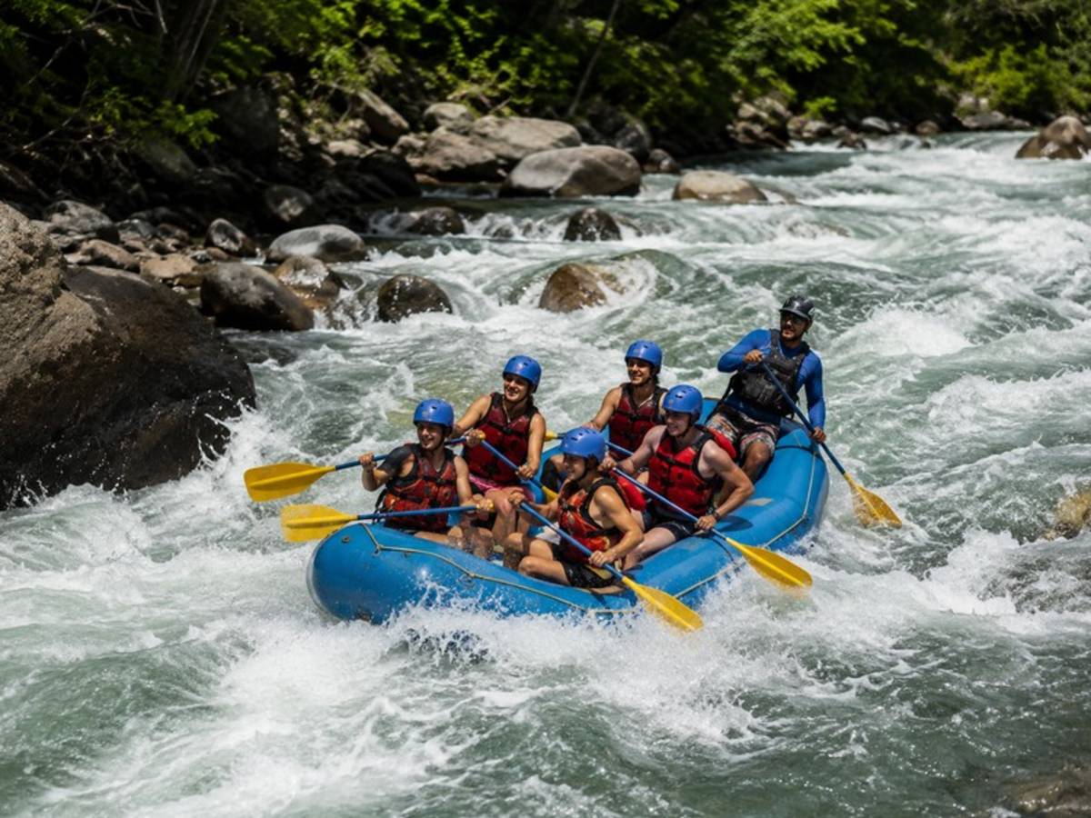 Travellers white water rafting through Costa Rica