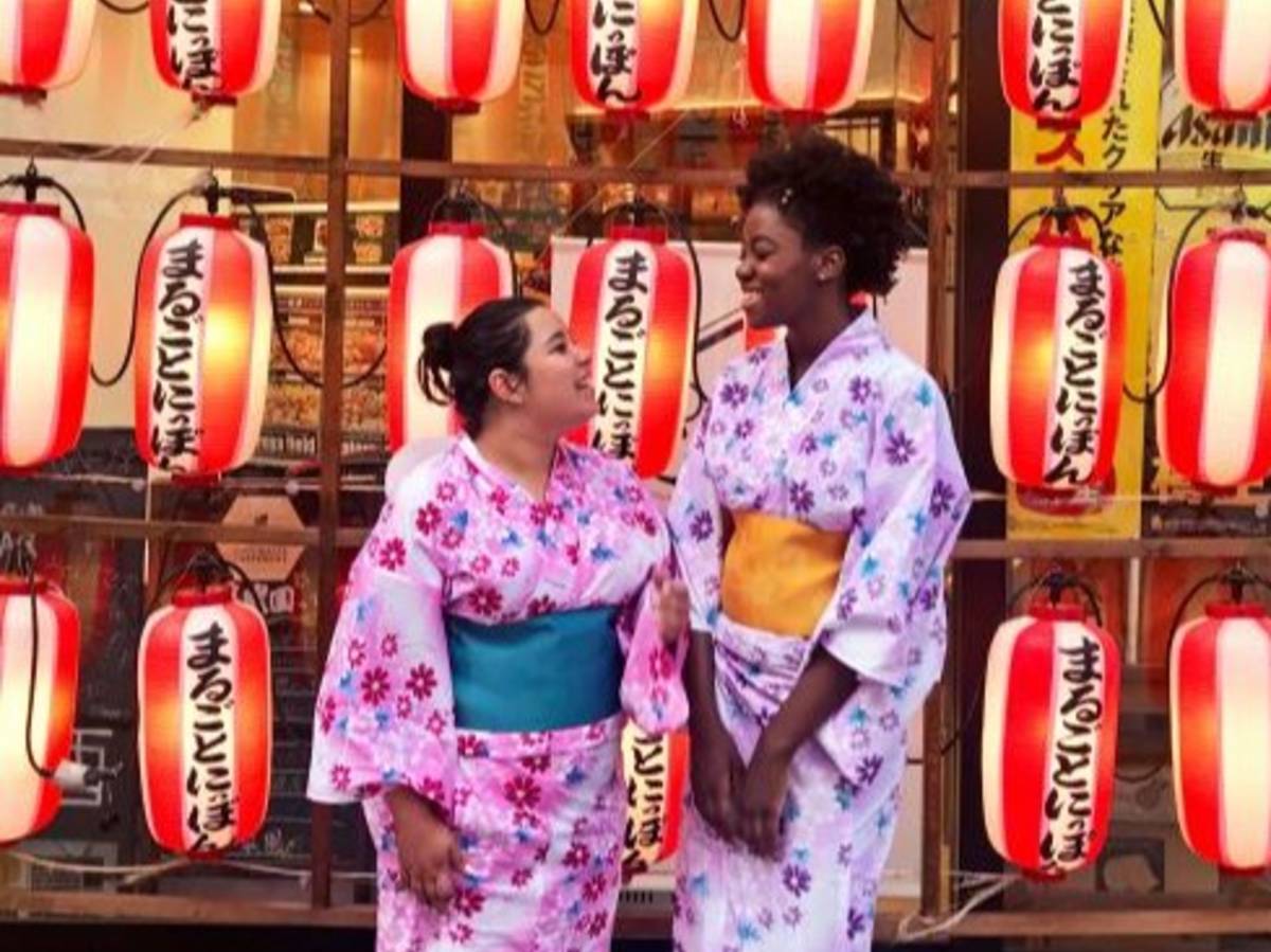 Two students smiling and wearing kimonos in Tokyo, Japan.