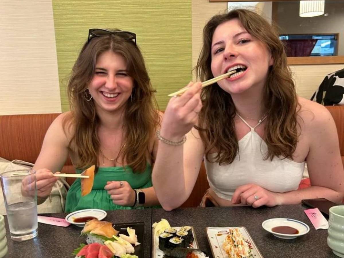 Two women eating Japanese food