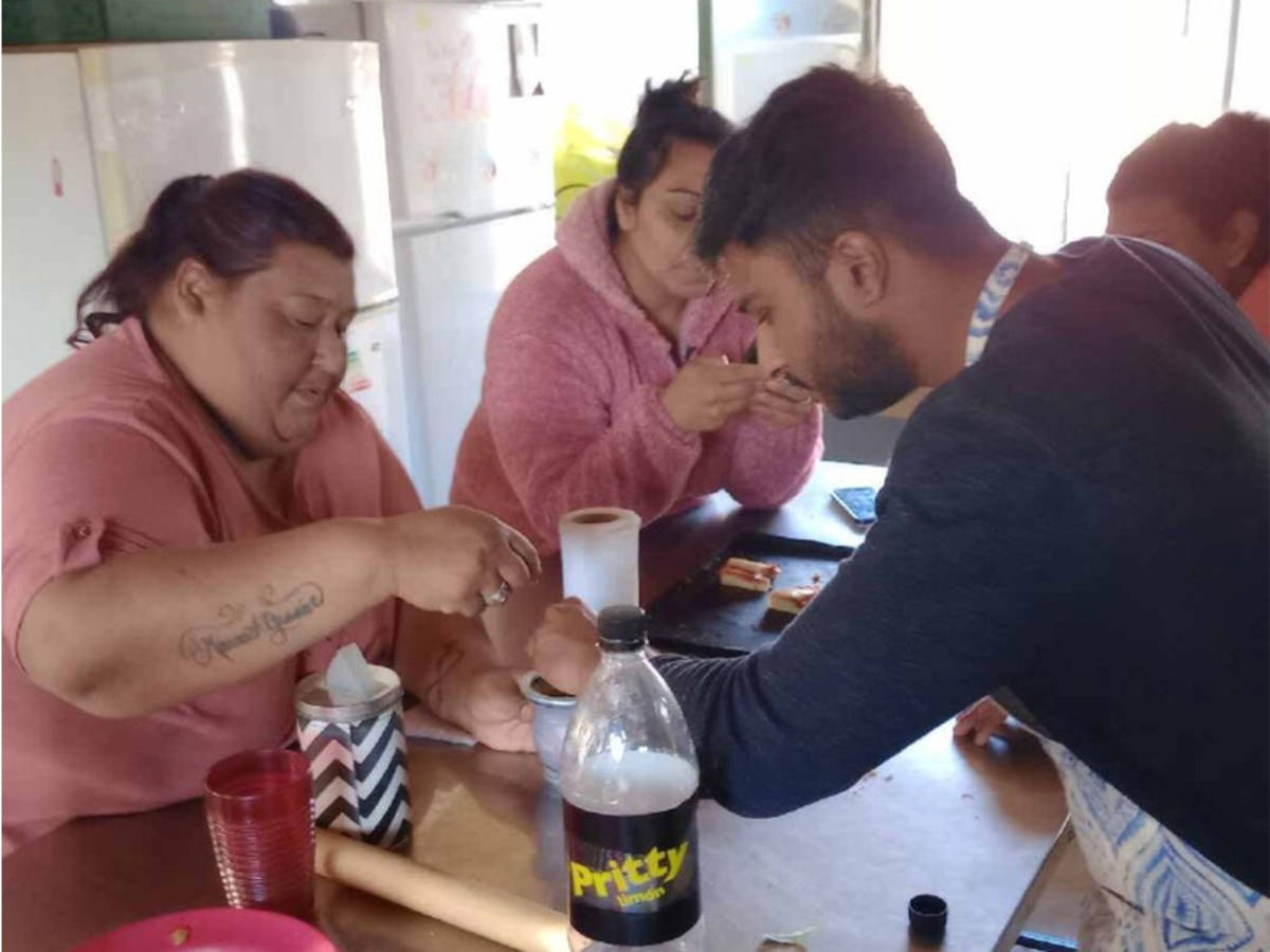 Volunteer helping at a soup kitchen for poor children.