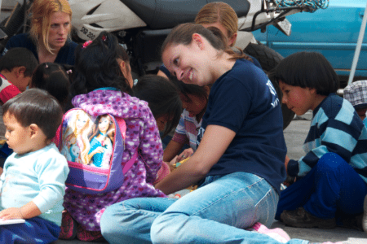 Volunteer teaching child