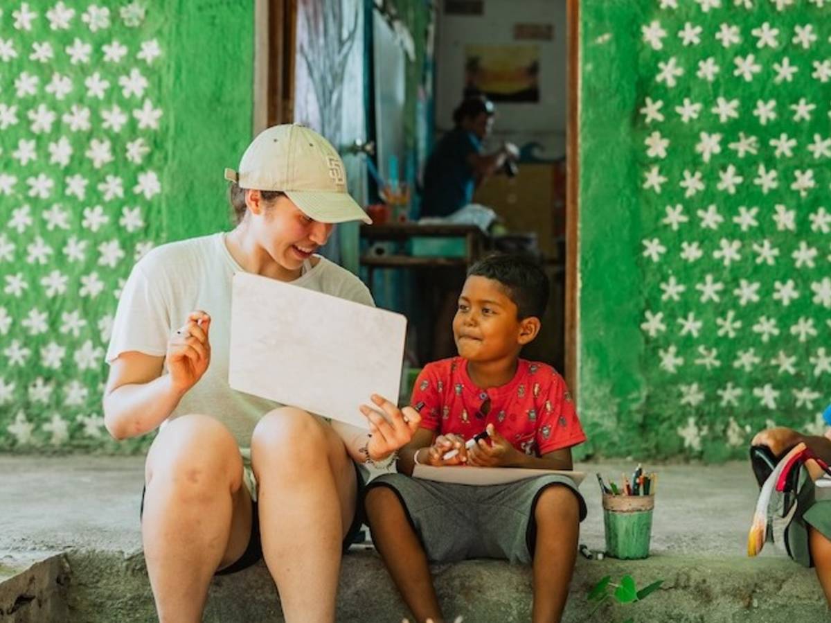 Volunteer teaching English at a local school to children