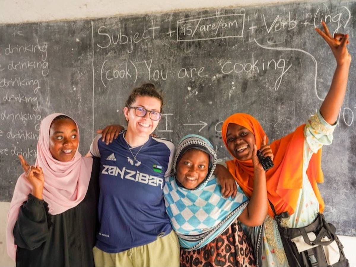 Volunteer teaching English to local Tanzanian students