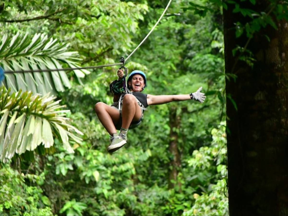 Volunteer zip lining through the jungles of Costa Rica
