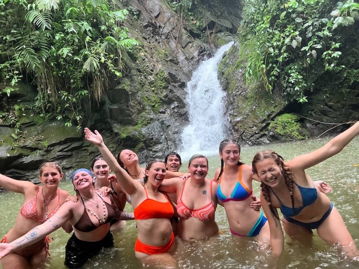 Volunteers having fun at a waterfall in the jungle of Costa Rica