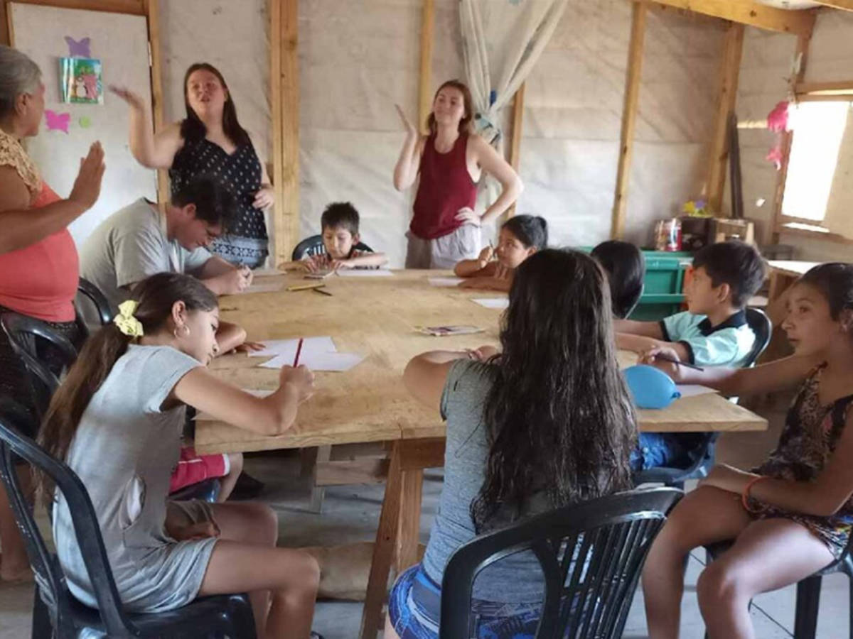 volunteers helping children
