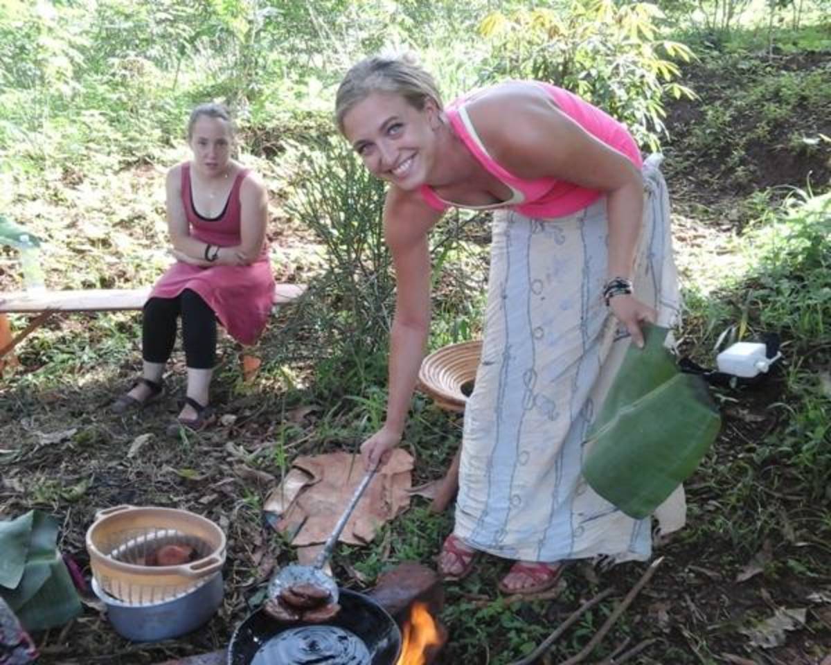 Volunteer learning to cook in rural Uganda, Africa