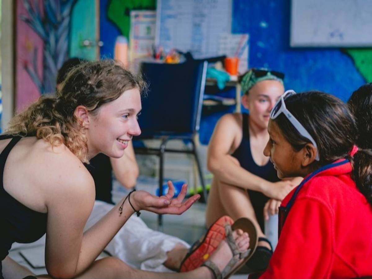 Volunteers teaching English to children at a local school