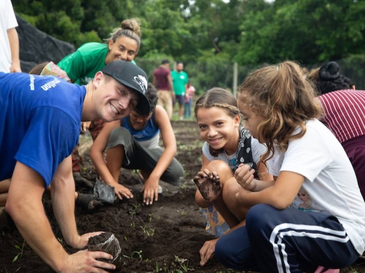 Volunteers working on sustainable garden with local children.