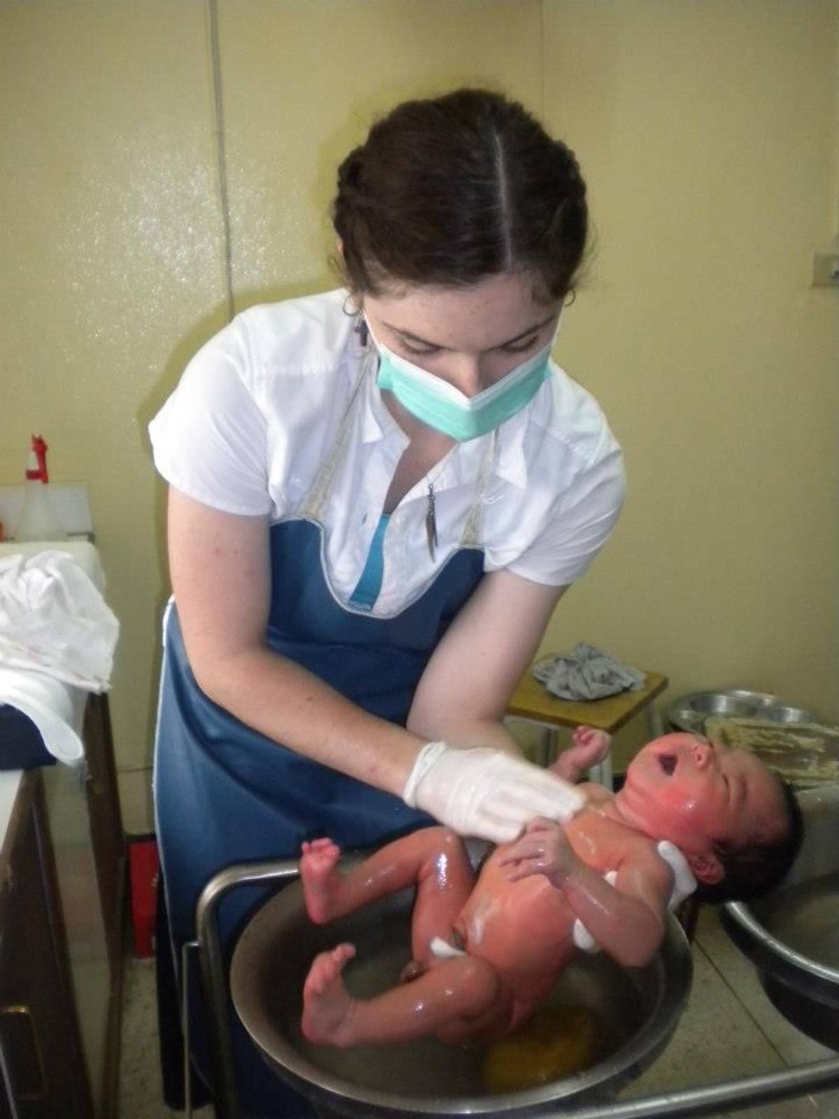 Volunteer washing the baby